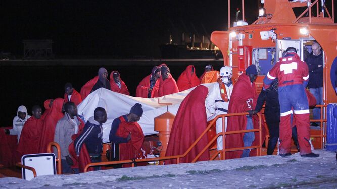 Personas rescatadas, ayer, de una de las pateras a su llegada al puerto de Málaga.