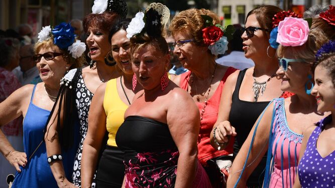 Un grupo de mujeres posan con sus vestidos de flamenca en el centro de Málaga.