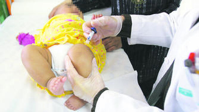 Un pediatra vacuna a un bebé