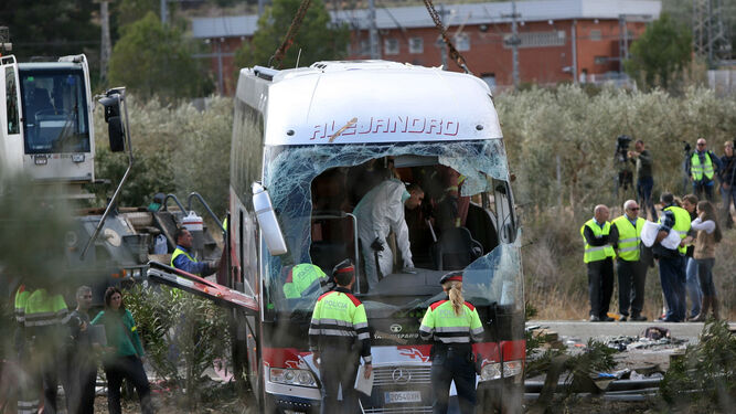 Agentes de los Mossos junto al autocar que chocó contra un vehículo en la autopista AP-7, a la altura de Freginals causando 13 fallecidos.