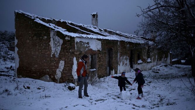 Una familia prepara una bola para construir un muñeco de nieve en El Saltillo.