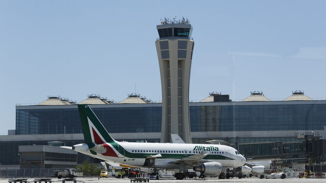 Un avión estacionado cerca de la torre de control del aeropuerto de Málaga.