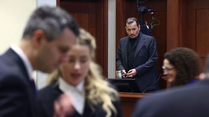 Johnny Depp, tras testificar. En primer plano, Amber Heard.