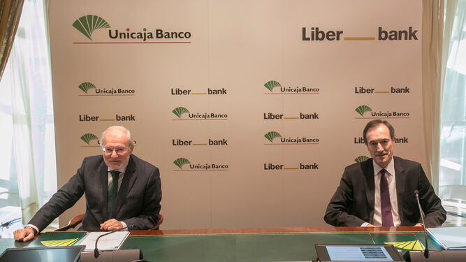 Manuel Azuaga y Manuel Menéndez cuando se formalizó la absorción de Liberbank.