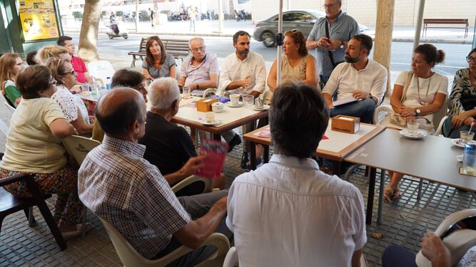 Representantes socialistas reunidos con vecinos en El Palo; fotografía de archivo.
