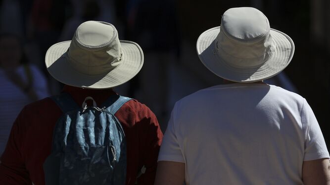 Dos turistas con sombrero en Málaga.