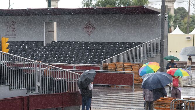 Un grupo de personas bajo el paraguas en la zona de calle Larios esta Semana Santa 2024